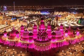 A vibrant scene at Global Village Dubai, with colorful pavilions representing different countries